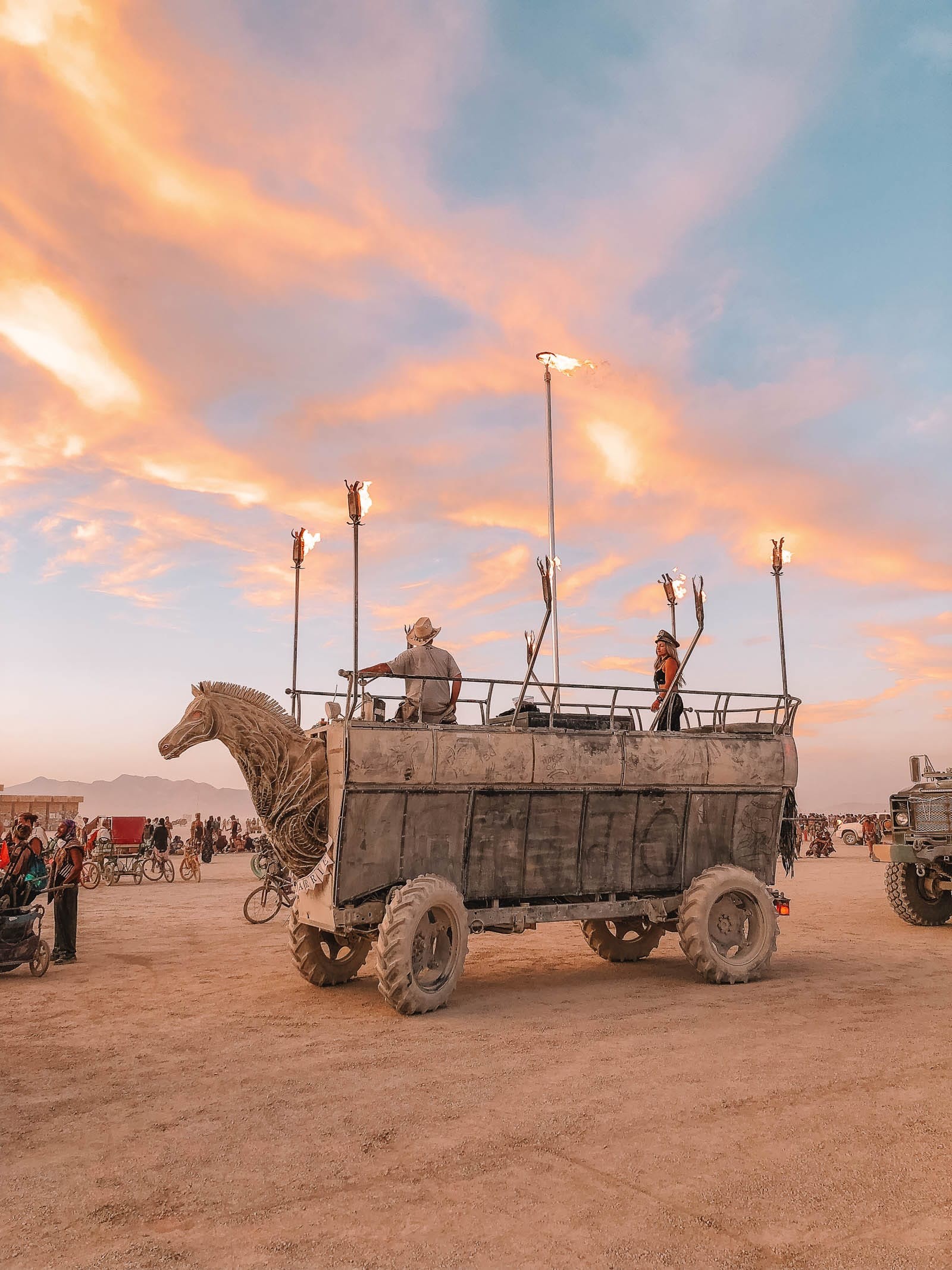 People interacting with a large-scale art installation at Burning Man during the daytime, emphasizing community engagement at nevada travel destinations