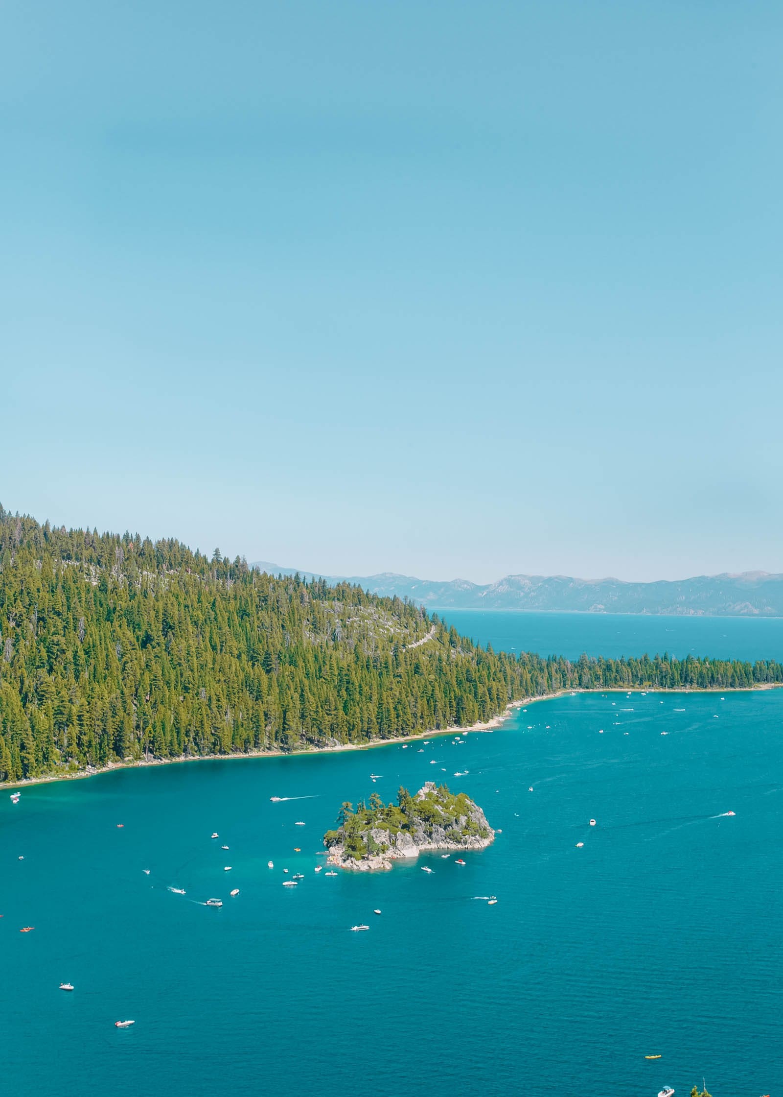 Mountains reflected in the clear waters of Lake Tahoe at sunset, capturing the serene beauty of nevada travel destinations