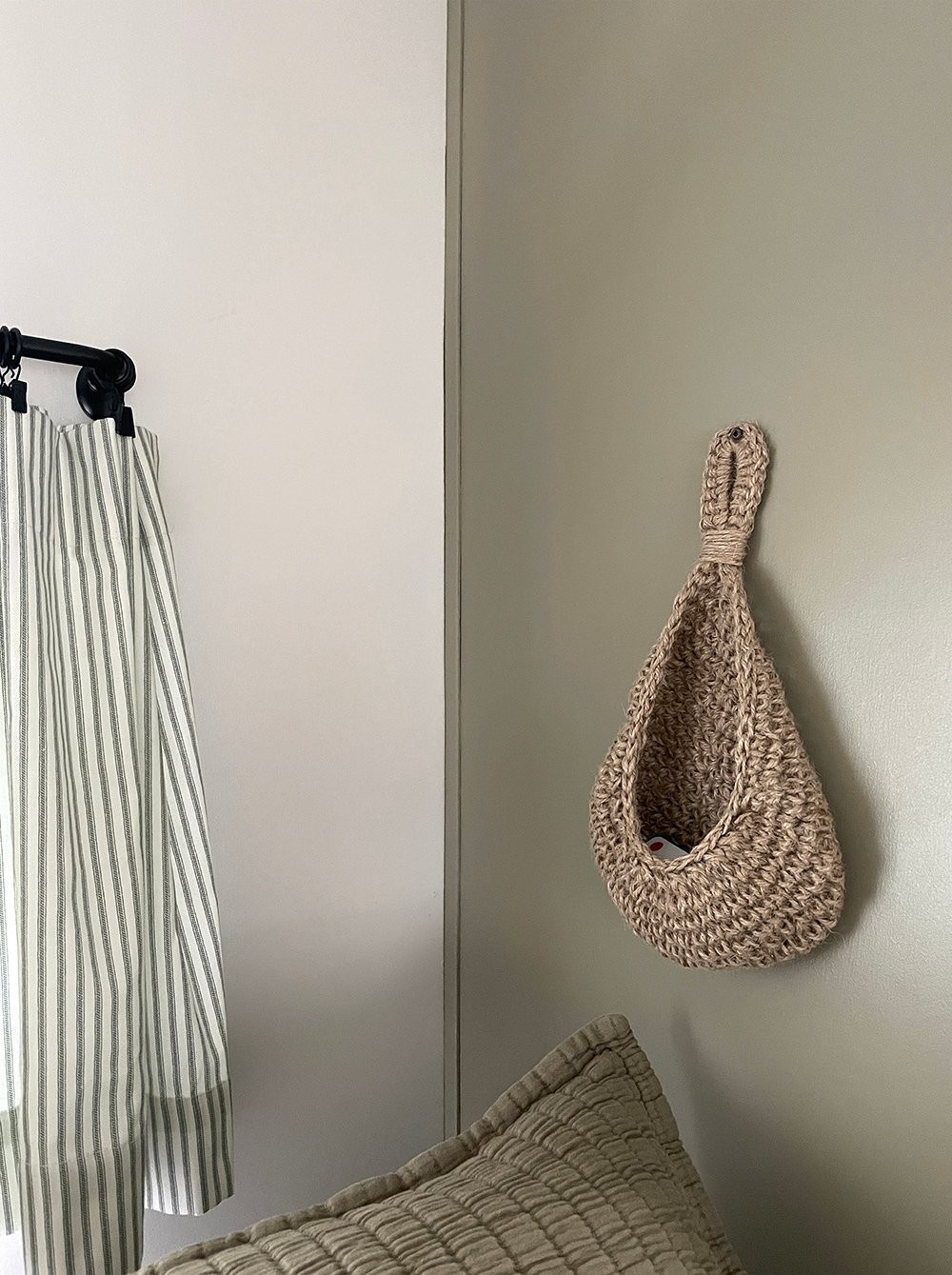 Woven hanging basket bag for small item storage next to camper bed