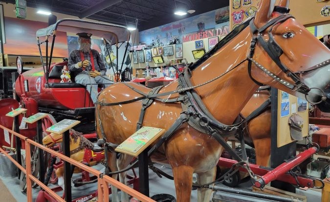 A horse-drawn wagon, representing a different era of transportation, on display