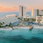 Hyatt Cancun resort in Mexico showcasing travel agent rates benefits with palm trees and beach view.