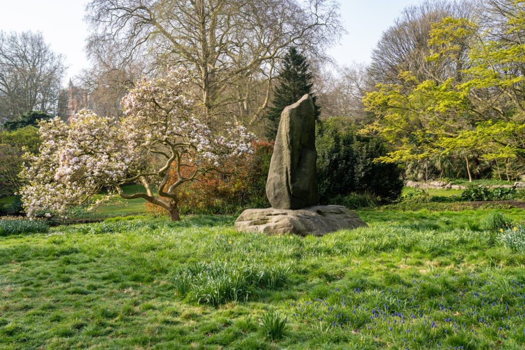 A scenic path winding through Hyde Park in London, with lush greenery and trees lining the way