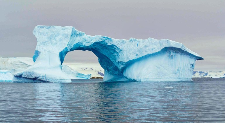 An ice bridge in Antarctica displays stunning natural formations and icy textures.