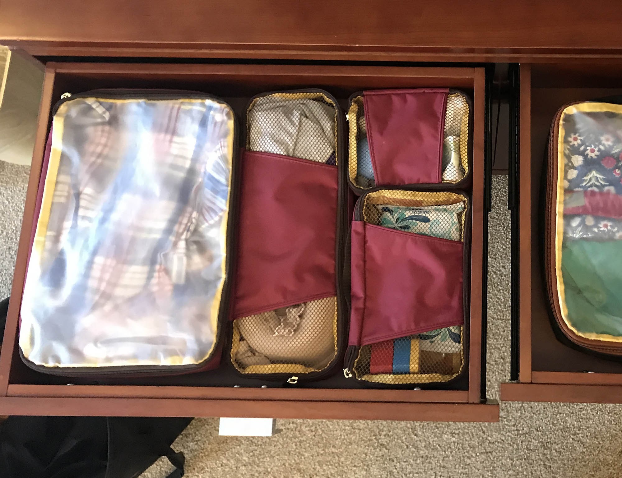 Open suitcase with neatly packed packing cubes inside