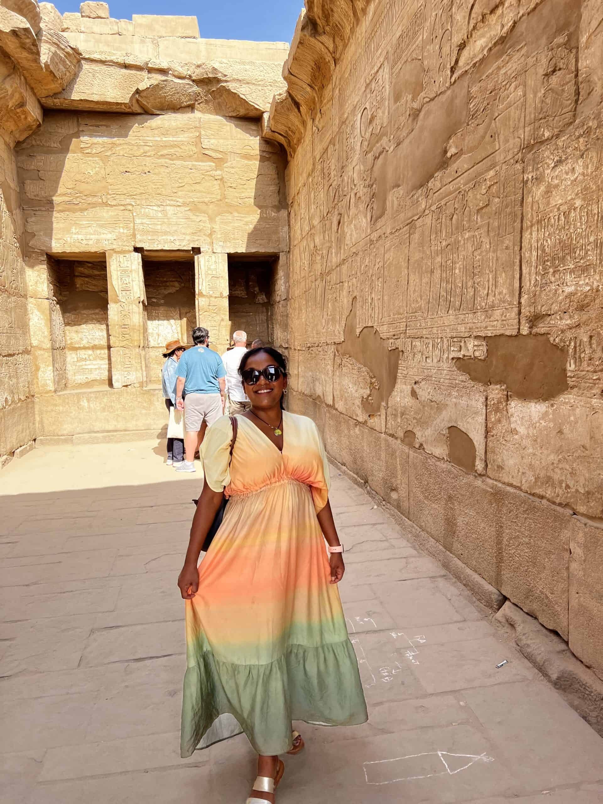 Two women in dresses and comfortable walking shoes in an Egyptian setting, illustrating stylish and practical travel wear for women.