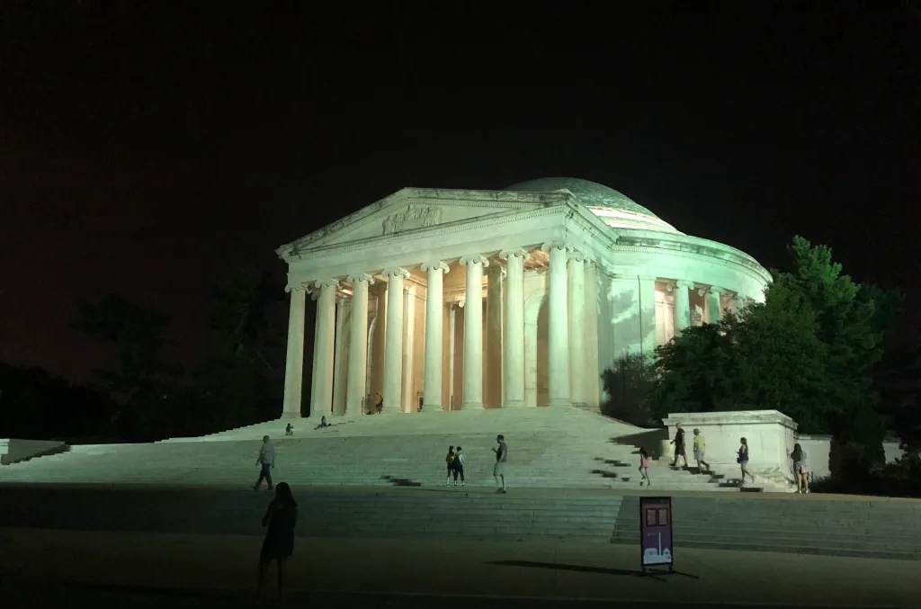 World War II Memorial at night, illuminated on the National Mall in Washington DC, part of the Monuments by Moonlight trolley tour