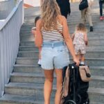 ruth nuss carrying the zoe travel stroller up some steps in sevilla