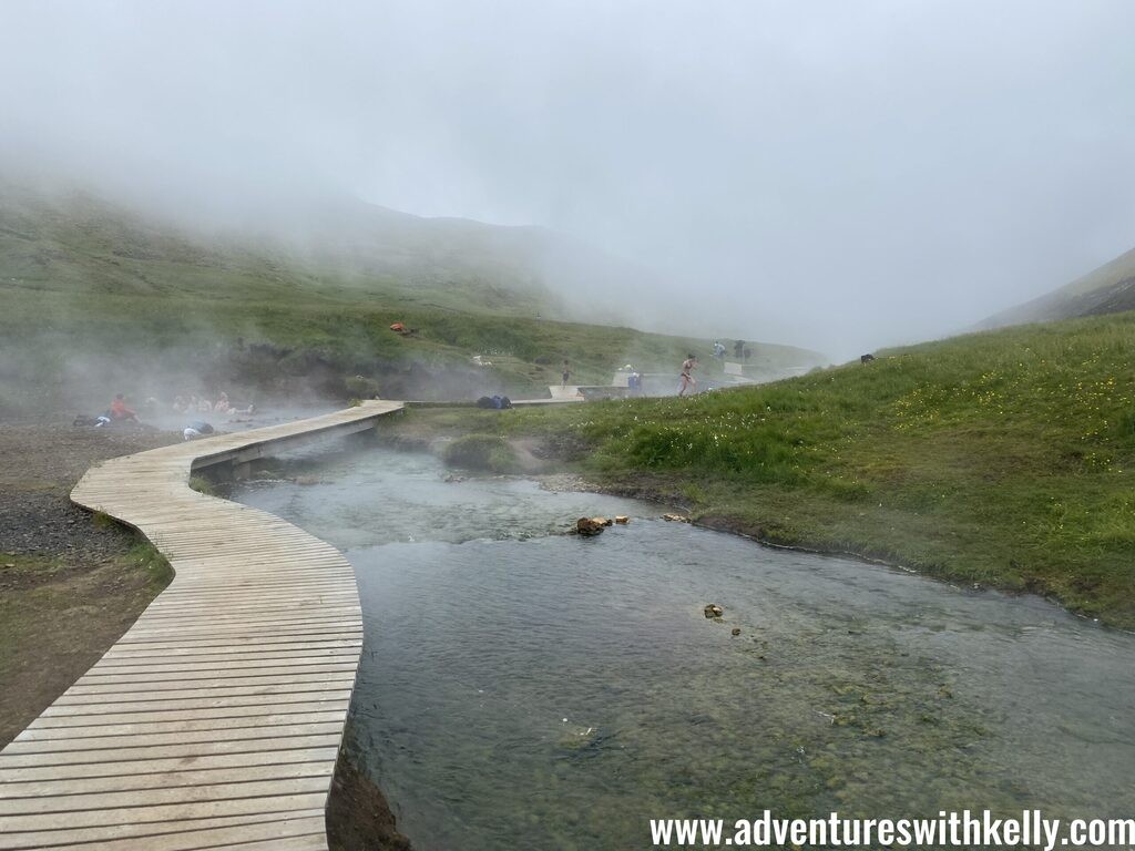 Hiking through the scenic Reykjadalur Valley towards the hot springs river.