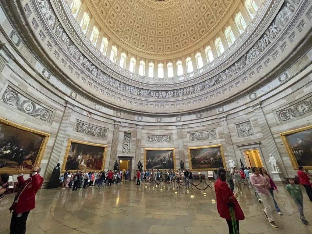 The Capitol Rotunda interior, showcasing its impressive dome and historical artwork in Washington DC