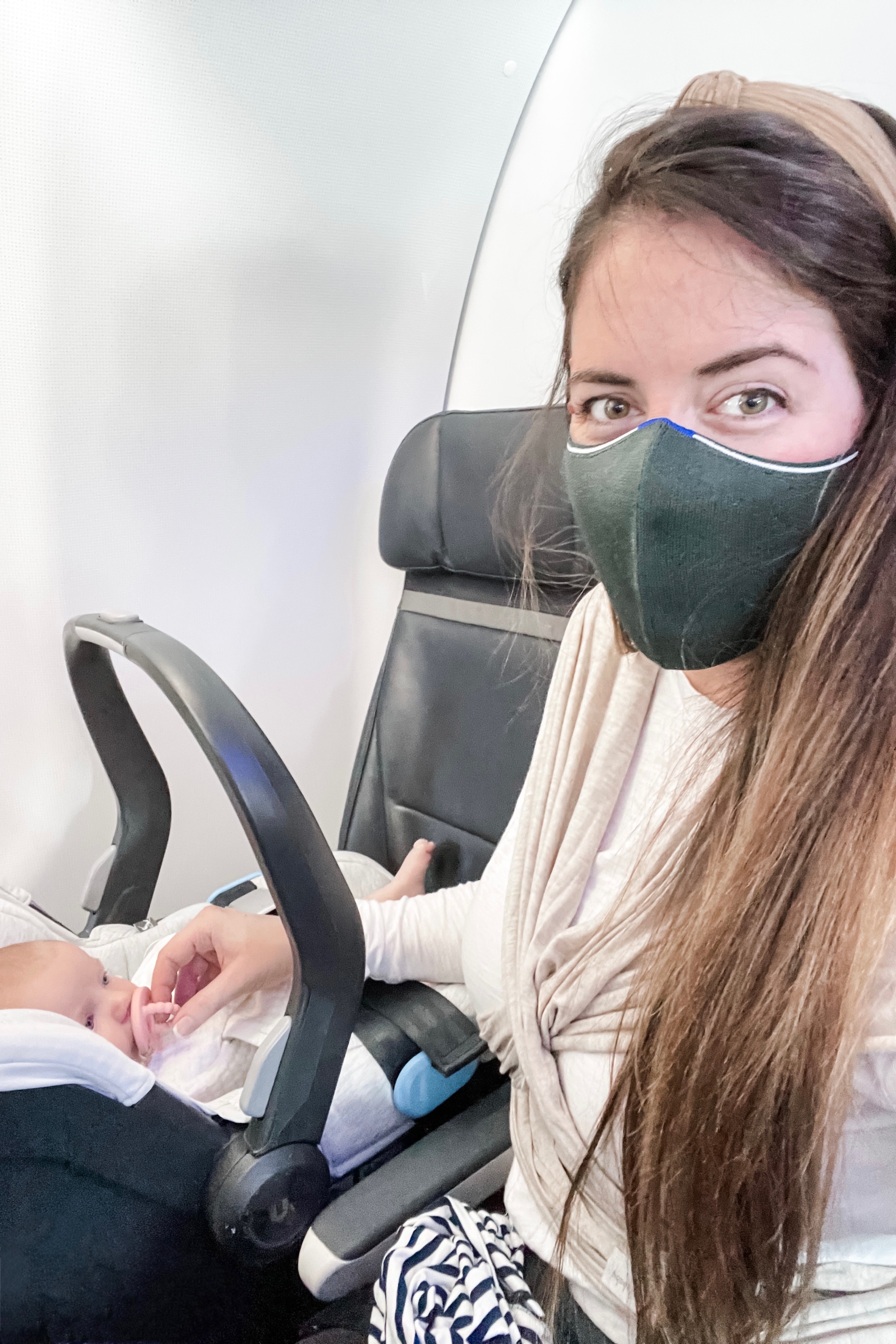 Infant car seat installed on an airplane seat, highlighting safety and comfort for baby during the flight.