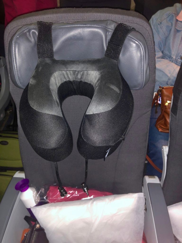 Cabeau Evolution S3 Travel Pillow on airplane seat headrest