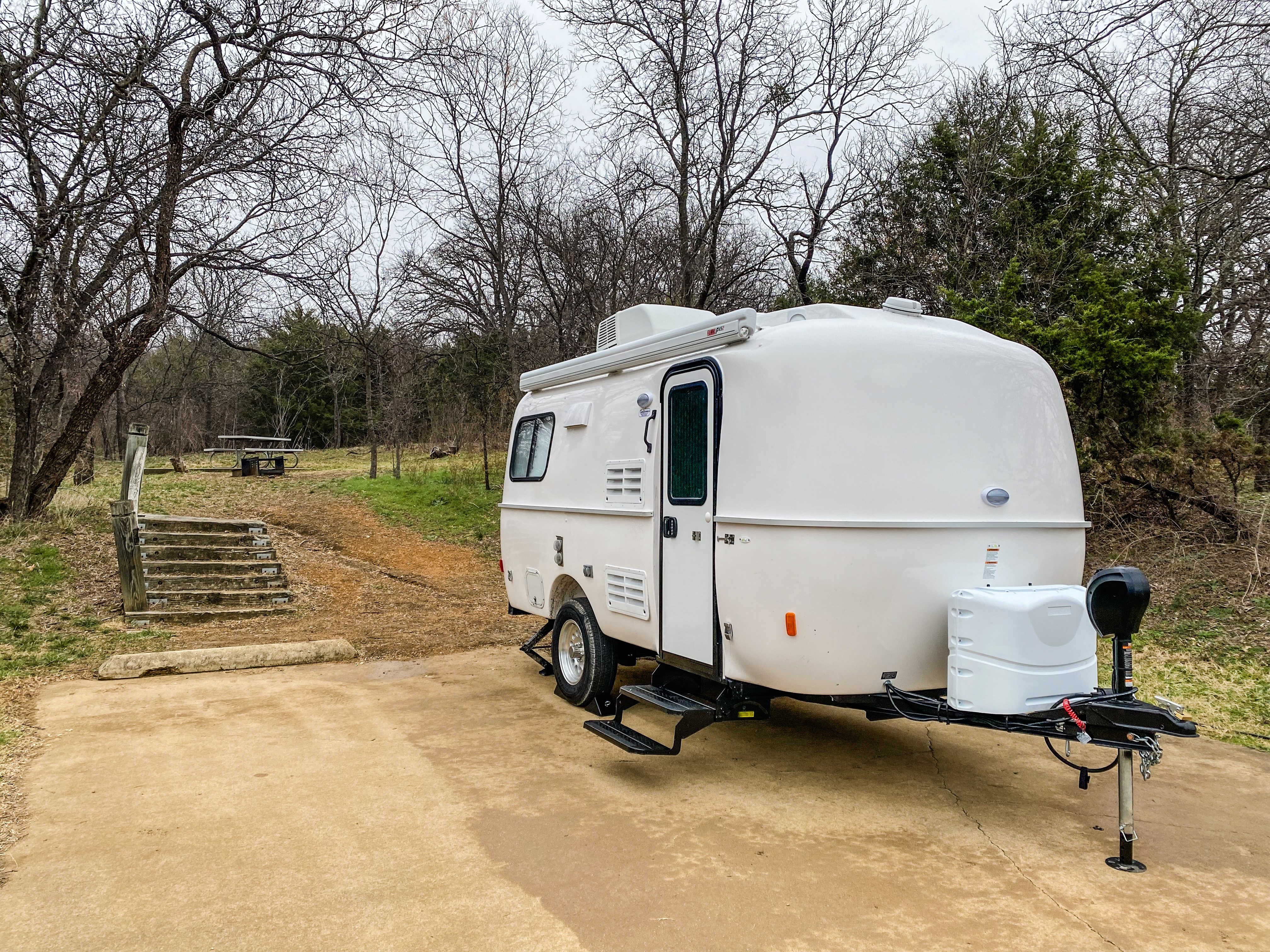 A row of new Casita travel trailers at the factory, showcasing their consistent design and build quality.