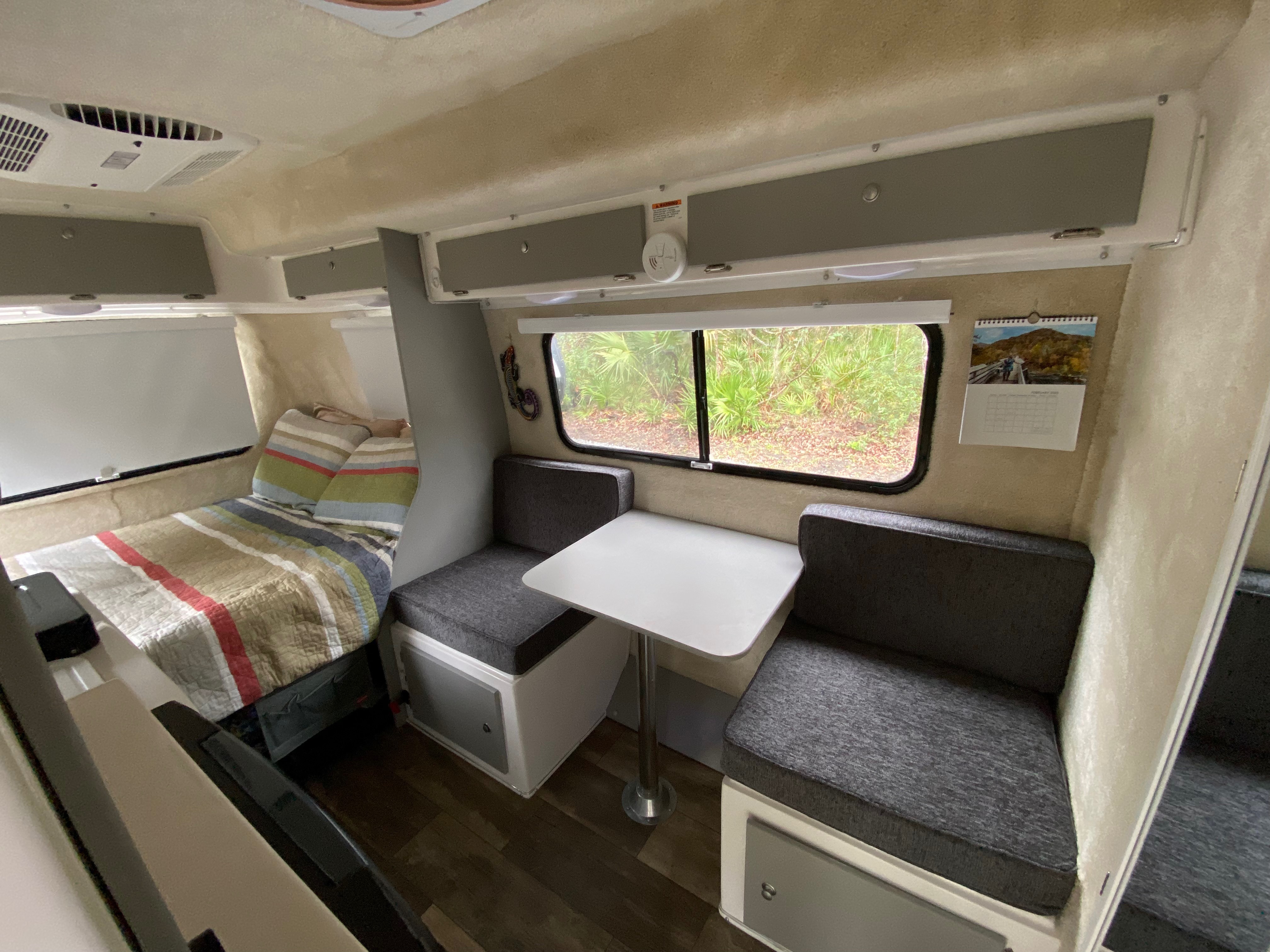 Interior of a Casita travel trailer, highlighting the dinette area and compact kitchen.