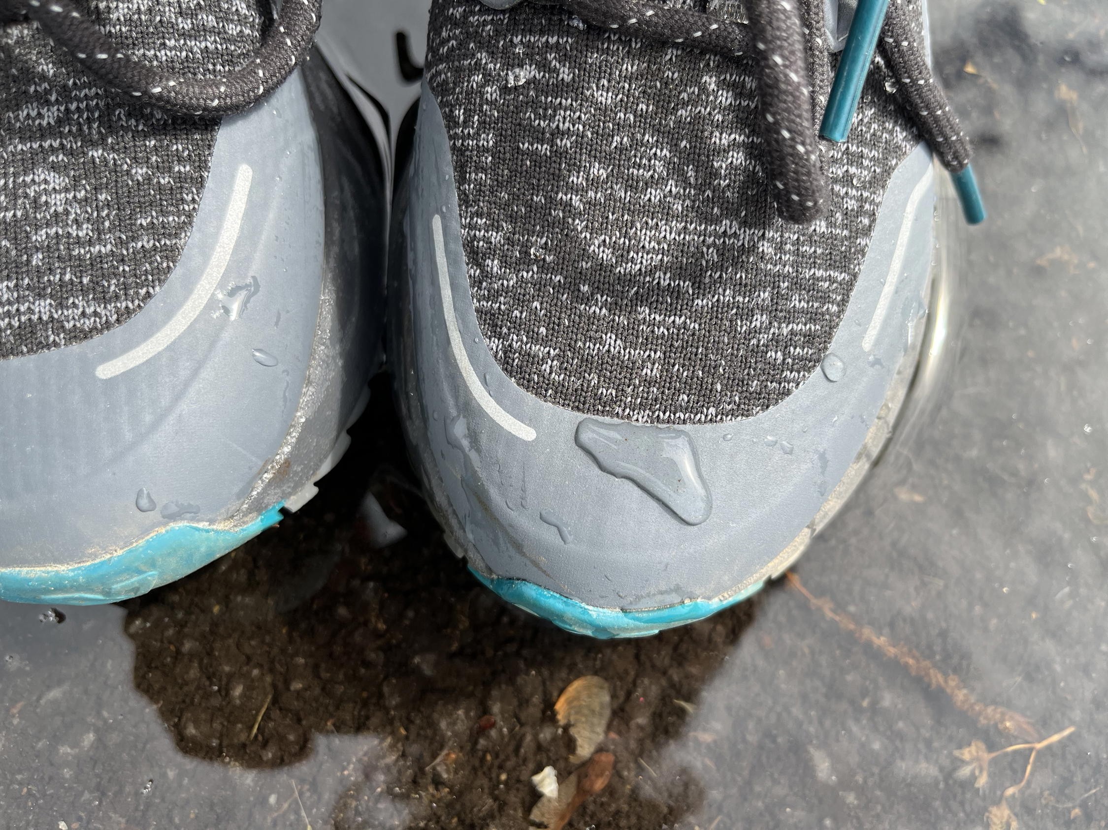 Woman holding a pair of Vessi Weekend Chelsea waterproof travel boots in hand, showing size.