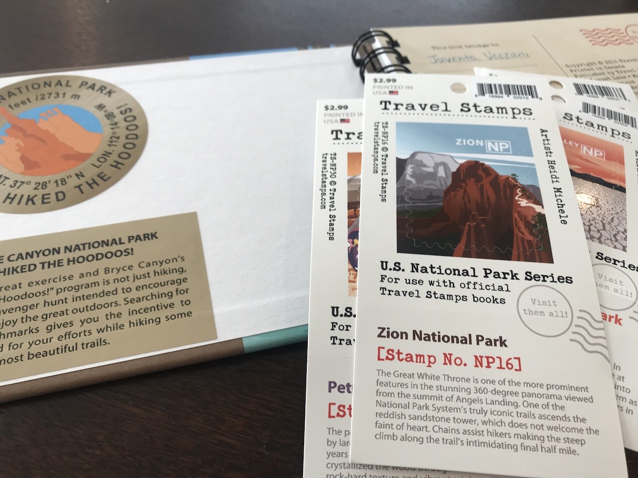 Close-up of Travel Stamps U.S. National Parks Album &amp; Guide cover art and logo