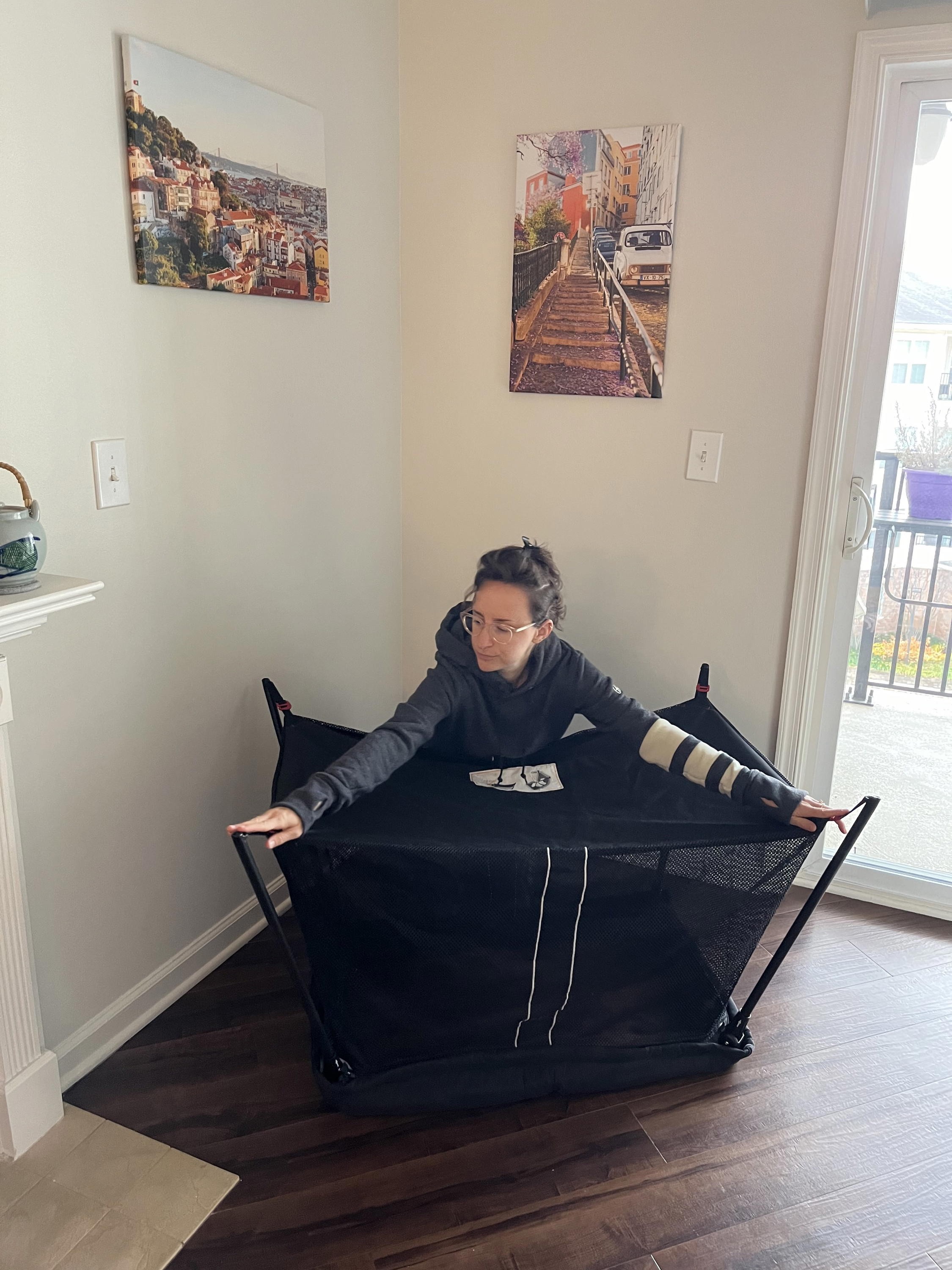 Women setting up the Baby Bjorn Travel Crib