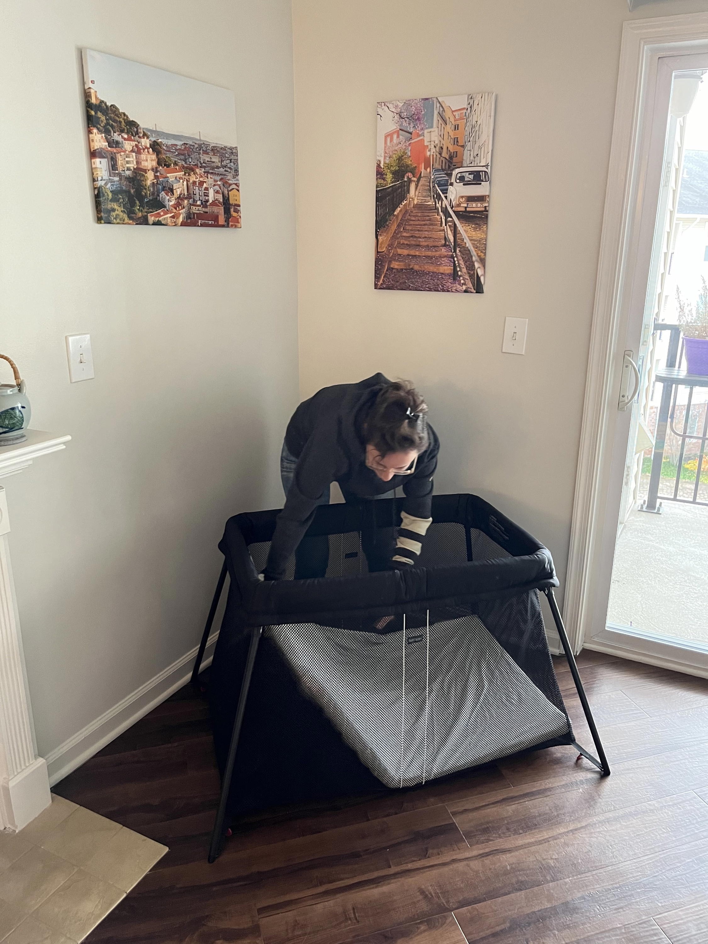 Women setting up the Baby Bjorn Travel Crib