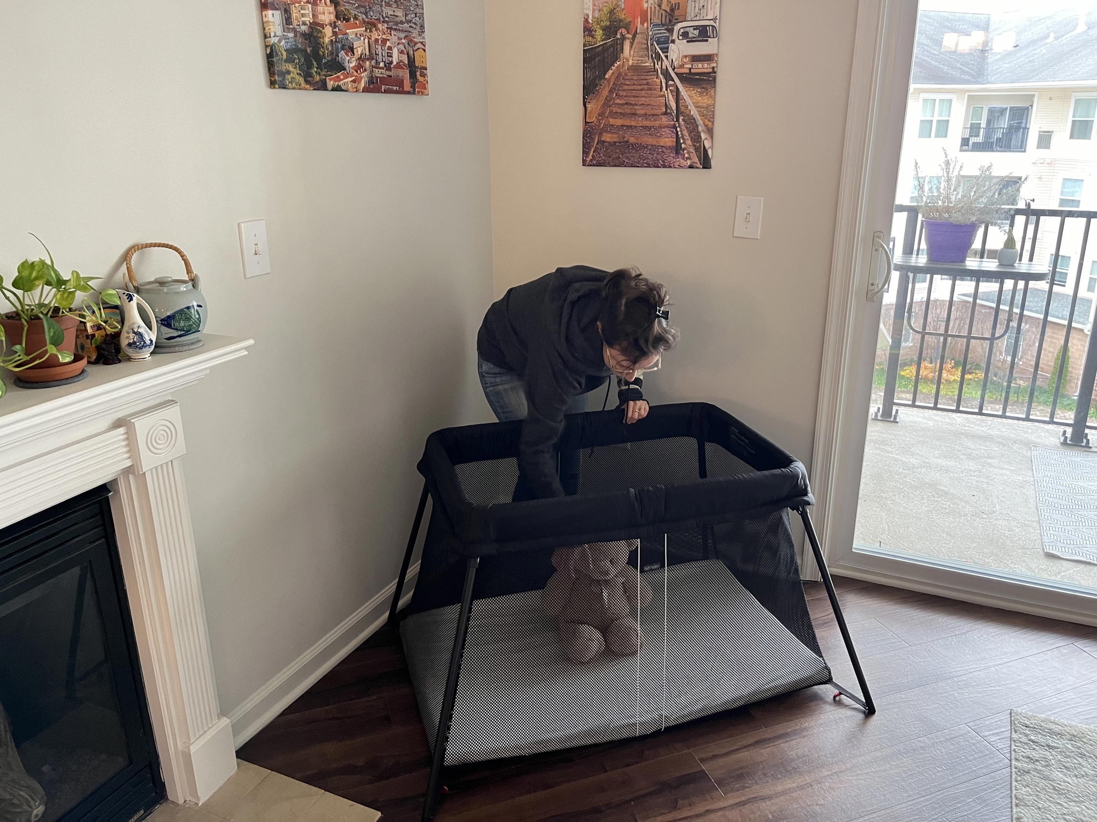 Women setting up the Baby Bjorn Travel Crib