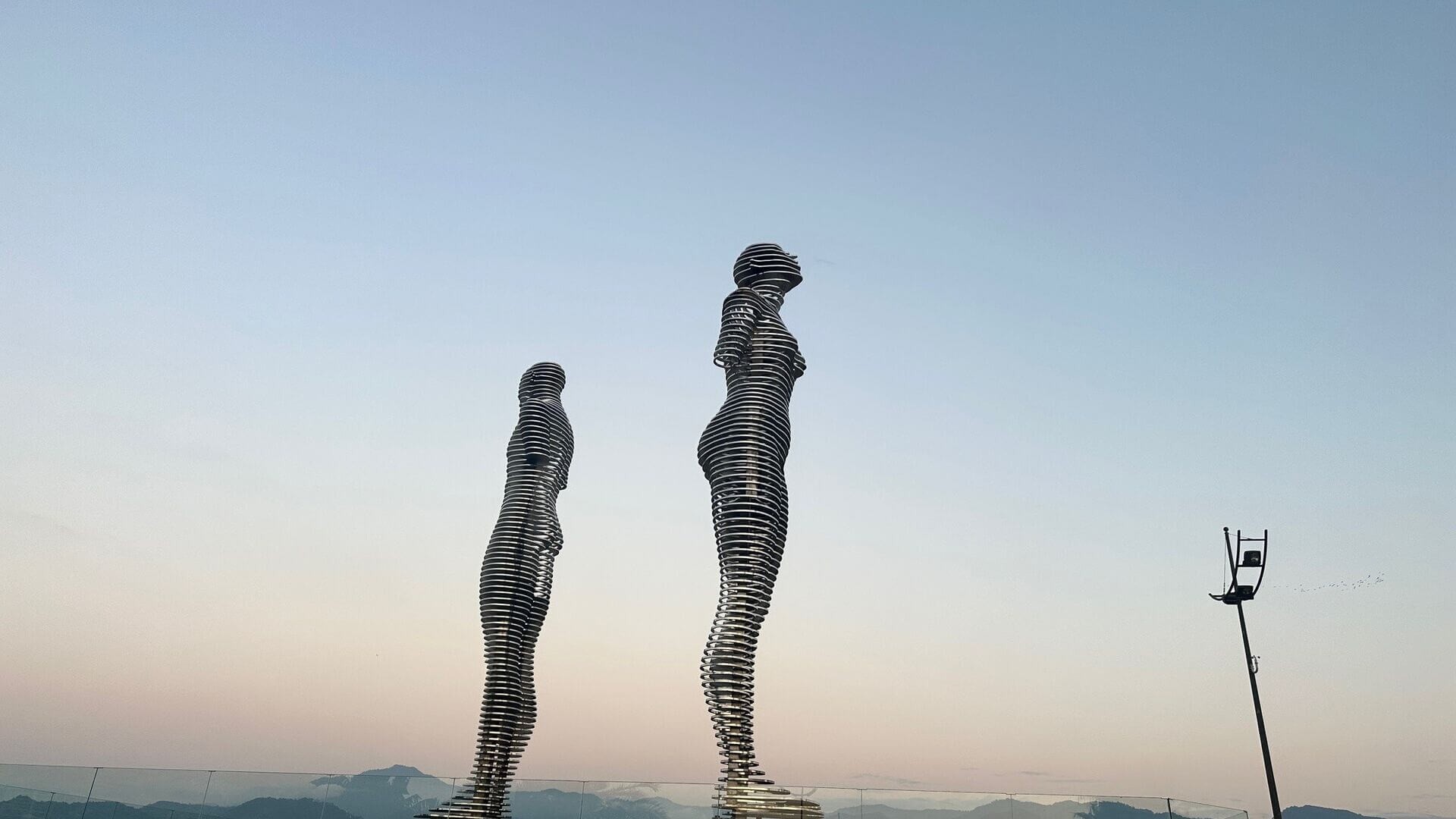 A modern art installation in Batumi featuring two figures, symbolizing the city's contemporary art scene and Black Sea location.