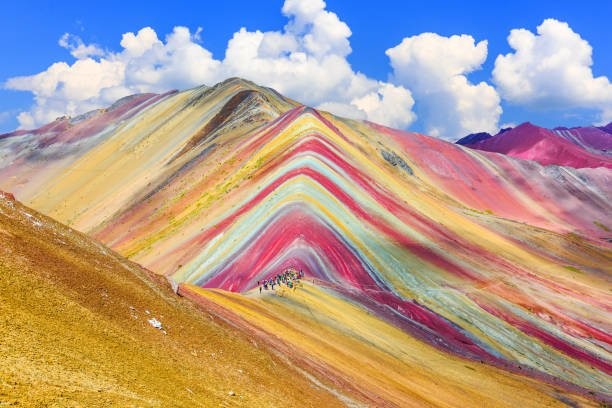 The vibrant colors of Rainbow Mountain (Vinicunca) in the Peruvian Andes, a must-see on any Peru travel itinerary.