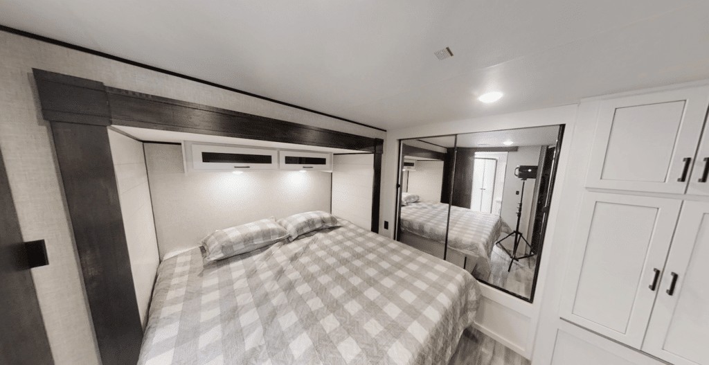 Bedroom in Jayco Jay Flight 340RLK travel trailer with king bed and wardrobe