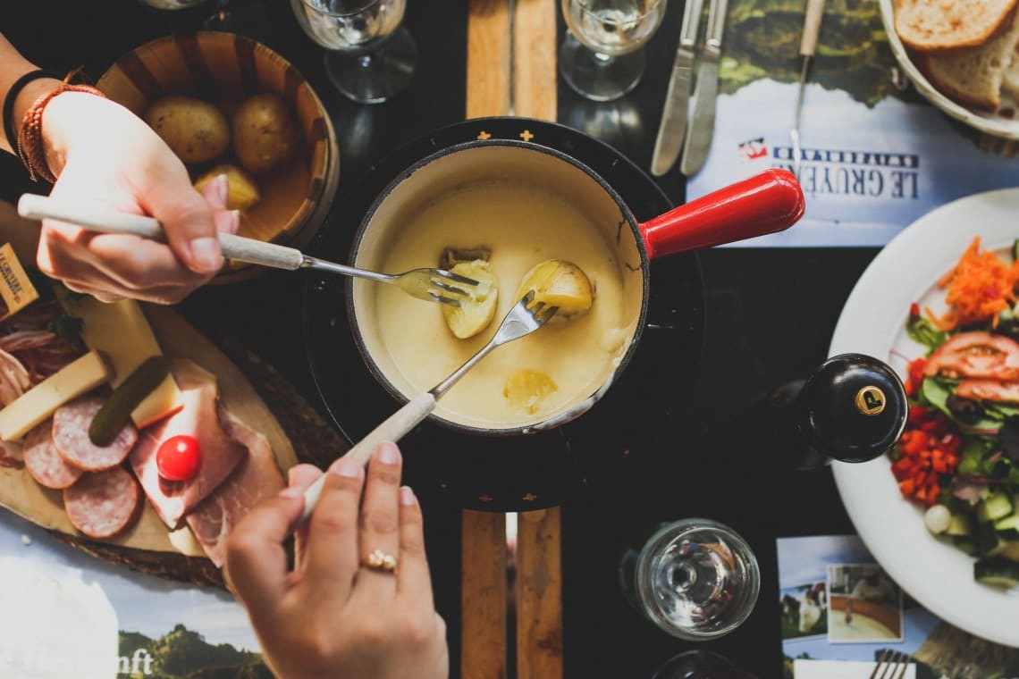 Indulging in cheese fondue in Switzerland.