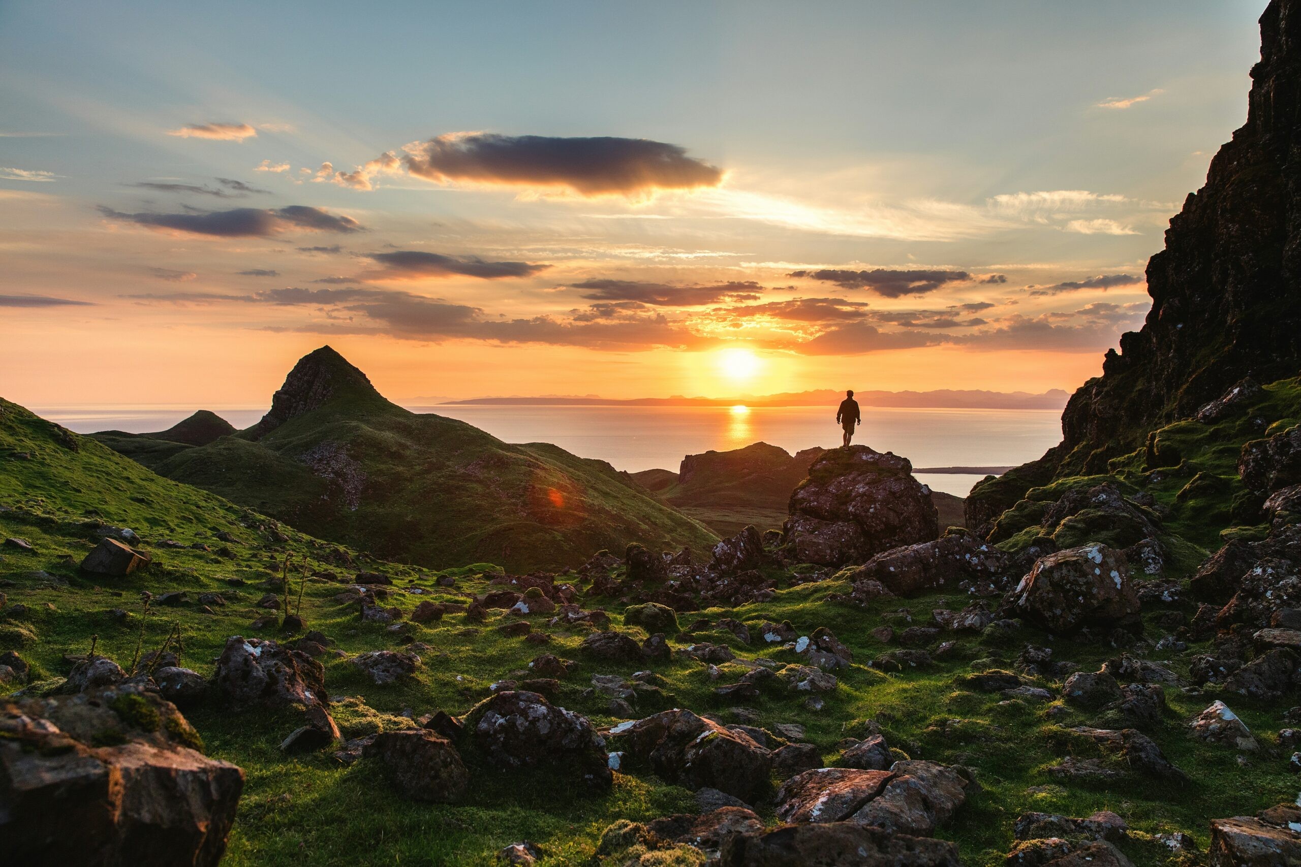 Dramatic sunset over the rugged landscape of Isle of Skye, Scotland, hinting at adventure and remote beauty for an anniversary trip