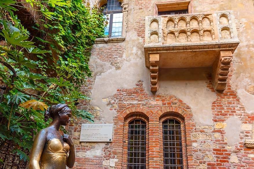 Juliet's statue and balcony in Verona, Italy, symbols of romantic Verona