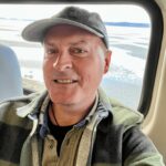 Travel expert Matthew Kessi takes a selfie on the train from Vancouver to Seattle, showcasing his nature-connected travel experience.