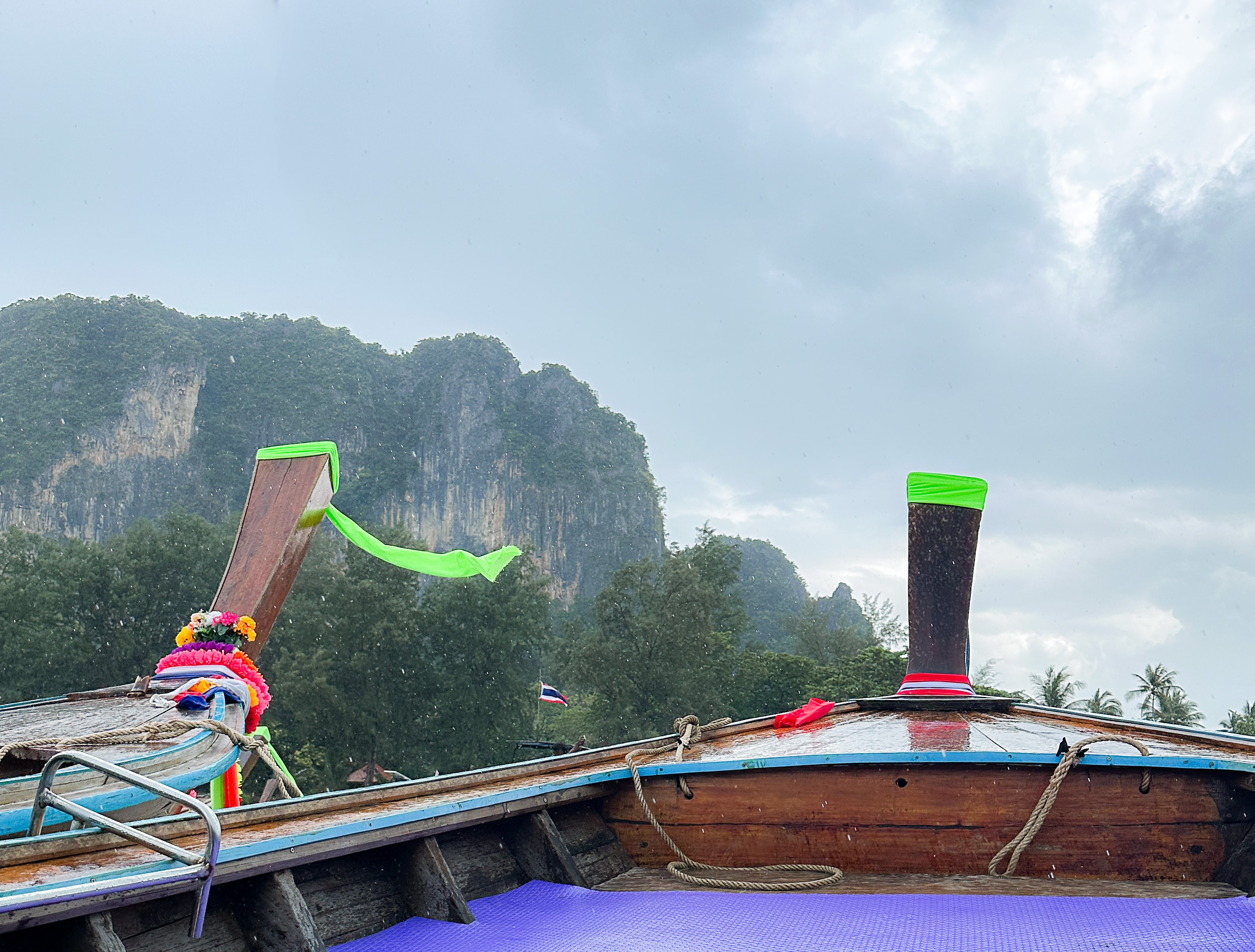 Palm trees and longtail boats on Railay Beach, Krabi, Thailand