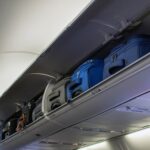 Carry-on luggage in overhead bins on an airplane