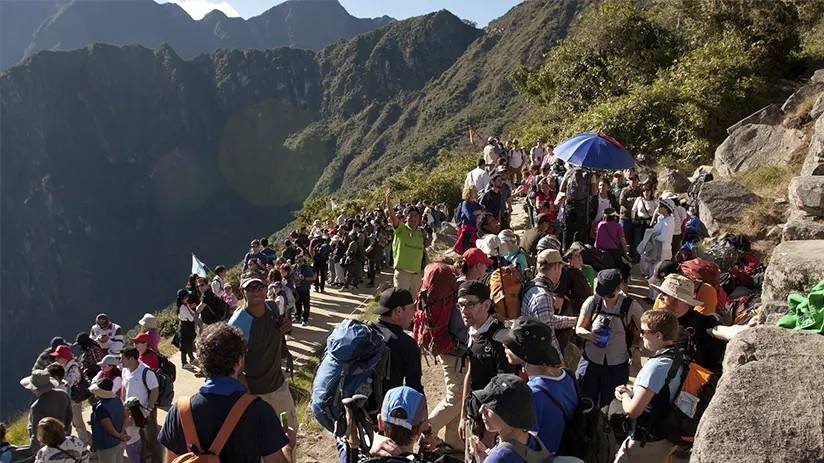 Photo of Machu Picchu during peak tourist season with many visitors and clear skies