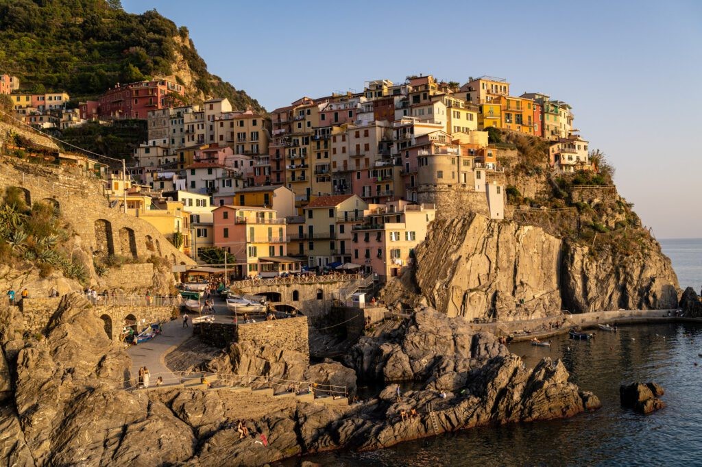 Sunset view of Manarola, Cinque Terre, with colorful houses clinging to the cliffside