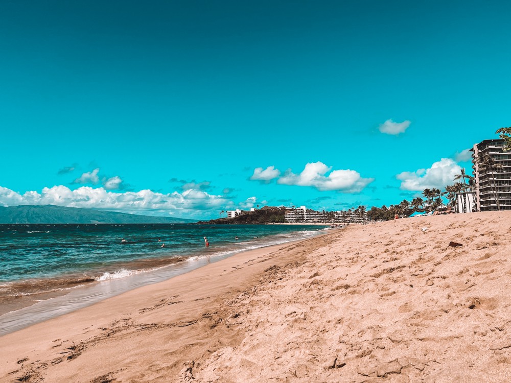 Woman looking at the ocean on a beach in Maui