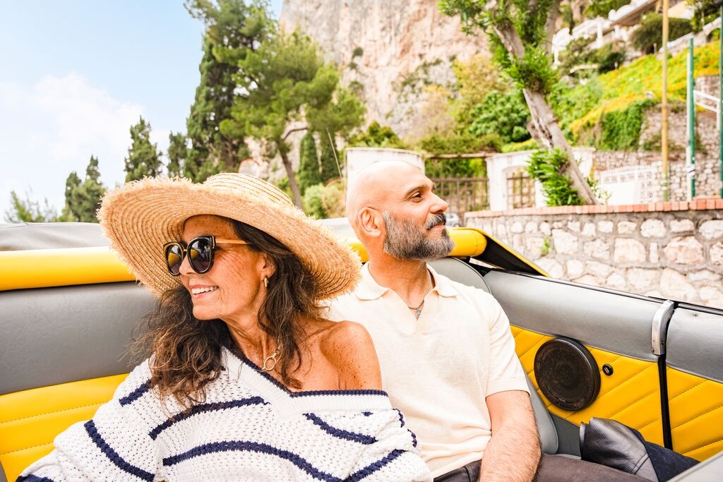 Couple enjoying a convertible ride in Capri, Italy, showcasing a luxurious and romantic travel experience