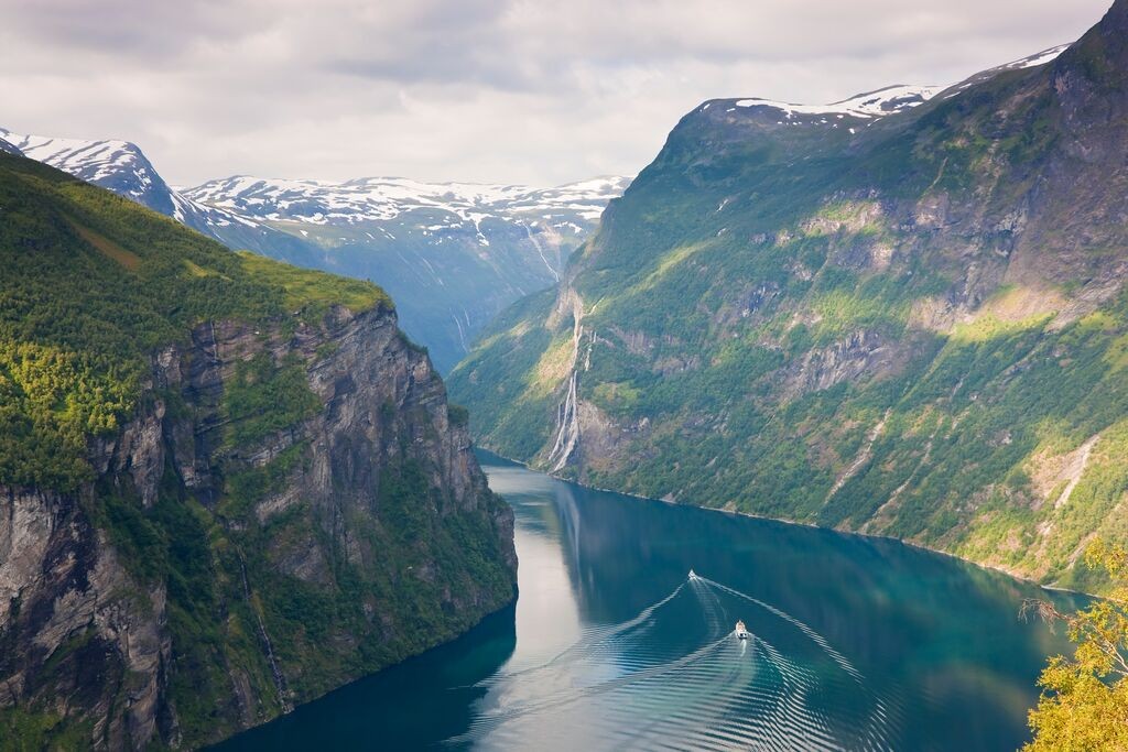 Breathtaking Geirangerfjord in Norway, with cruise ships and dramatic fjord landscapes, representing natural wonder and adventure for an anniversary