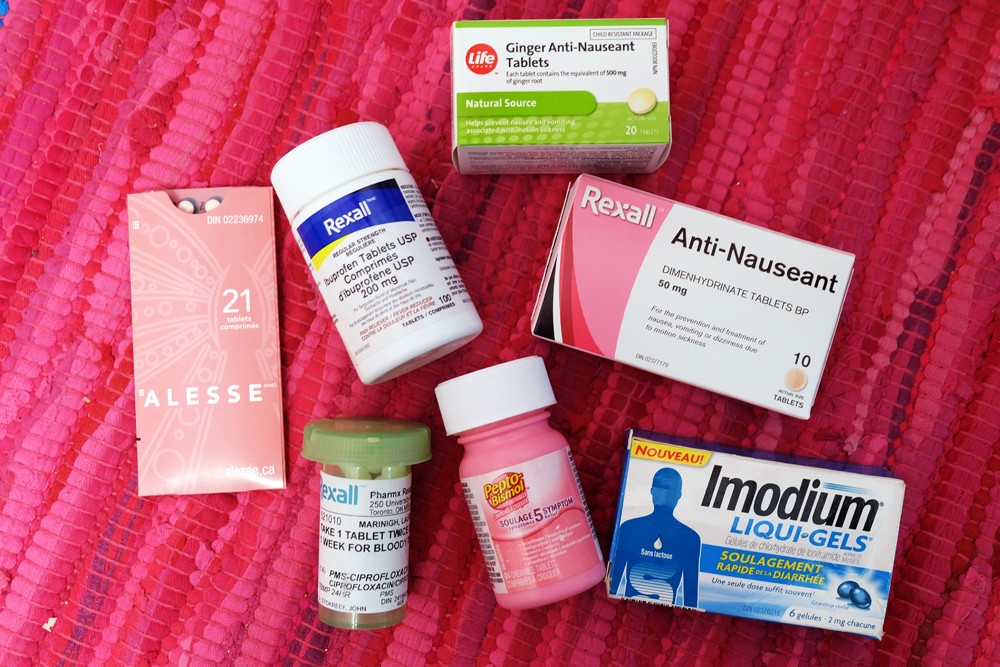 Pills and medication containers, emphasizing the importance of health items in a travel toiletry bag.