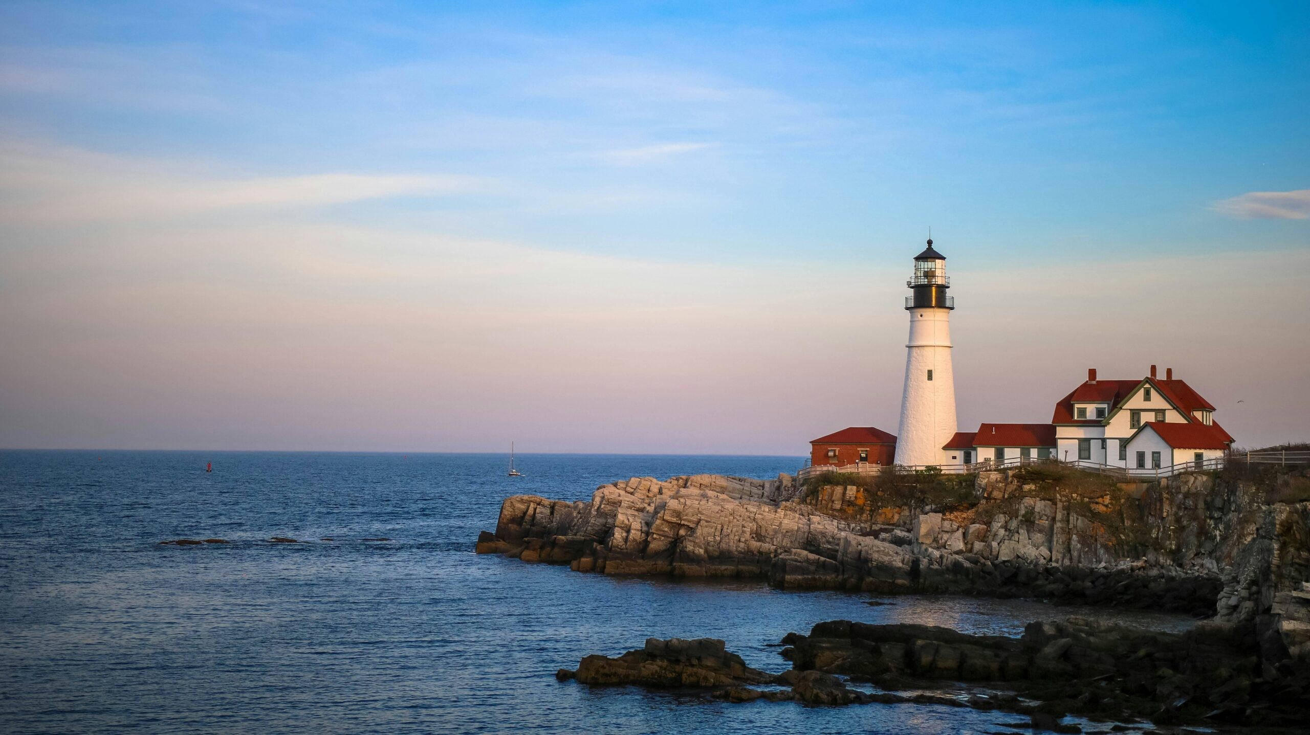 Picturesque lighthouse at sunset in Maine, New England, suggesting a serene coastal getaway for a peaceful anniversary