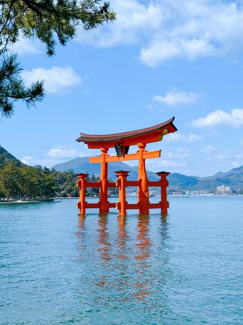 Iconic giant torii gate of Itsukushima Shrine in Miyajima, seemingly floating on water