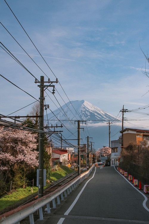 Mount Fuji, serene and snow-capped, reflected in a lake