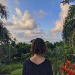 A woman immersed in the vibrant green jungle of the Dominican Republic