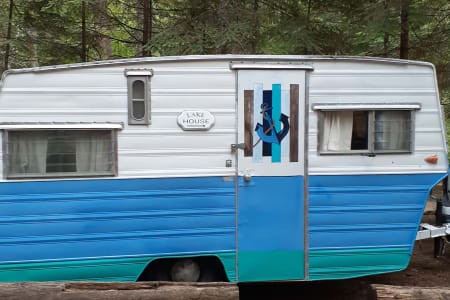 Exterior view of a vintage Aristocrat Lo-Liner travel trailer, highlighting its classic design and compact size.