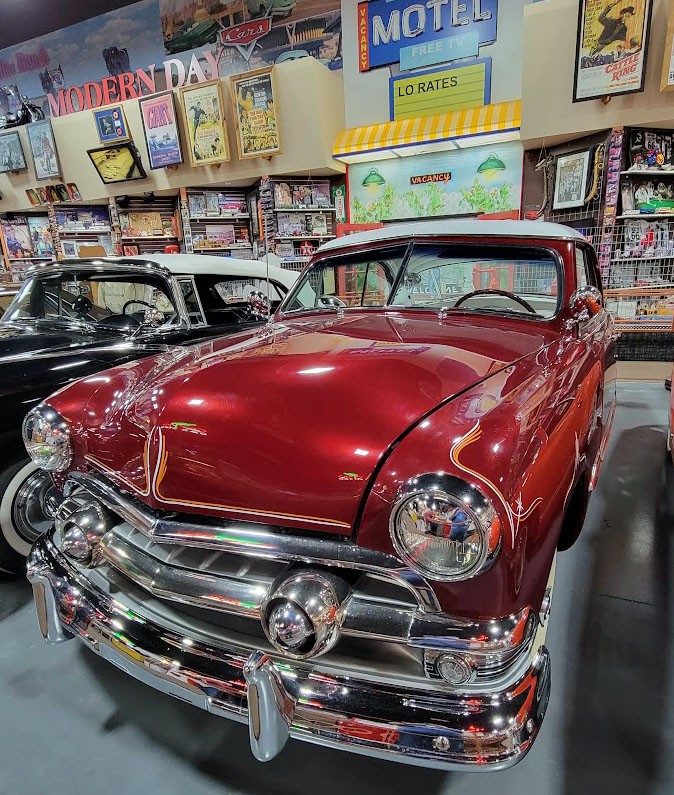 Close-up of a classic car's front grill and headlight in the museum