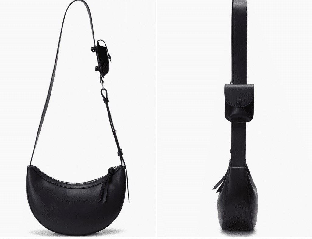 A crescent-shaped black leather bag with a long crossbody strap and a tiny pocket on the strap.