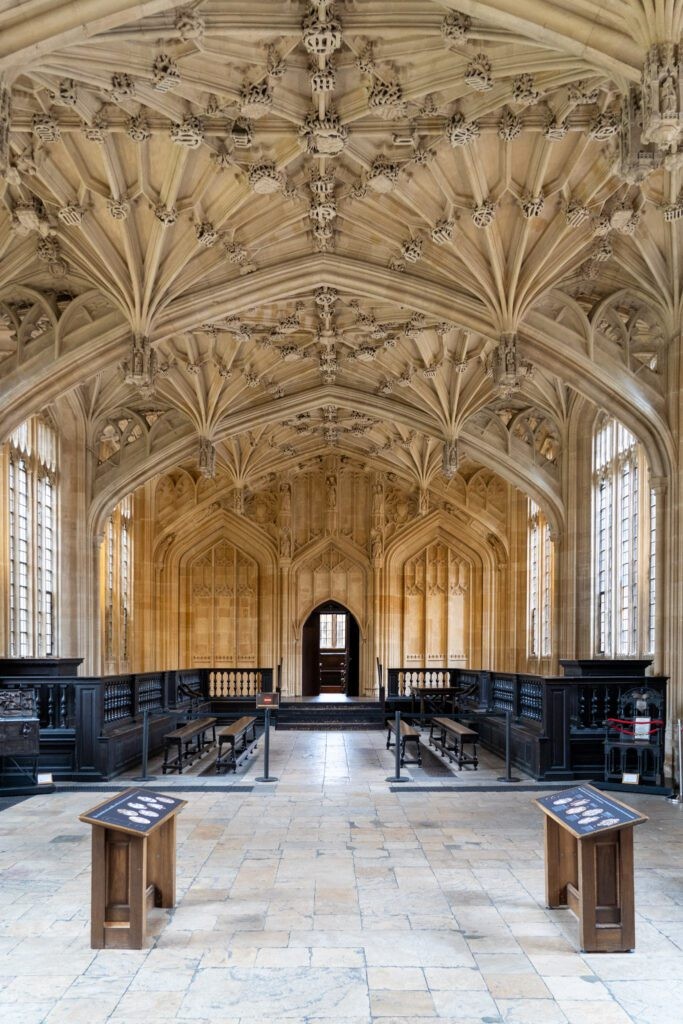 Inside Christ Church College Library in Oxford, a grand library with high ceilings and rows of books, also a Harry Potter filming location