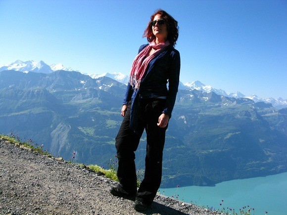 Woman wearing Anatomie Cosima Cozy Coverup in the mountains, showcasing lightweight yet durable travel layers for women.