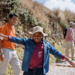 A child on an Adventures by Disney tour smiles holding a paddle in Peru