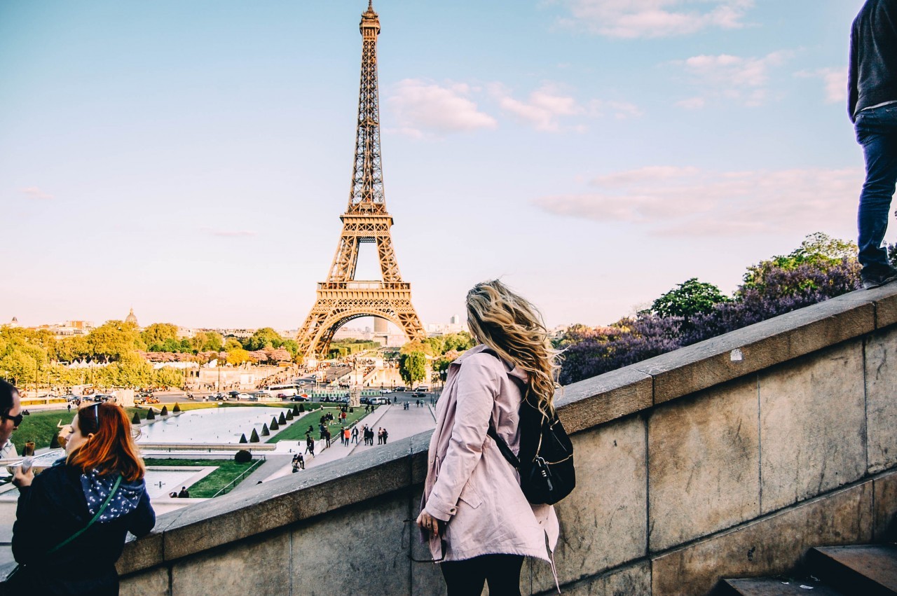 The Eiffel Tower majestically rising above Parisian buildings, viewed from Trocadéro Plaza.