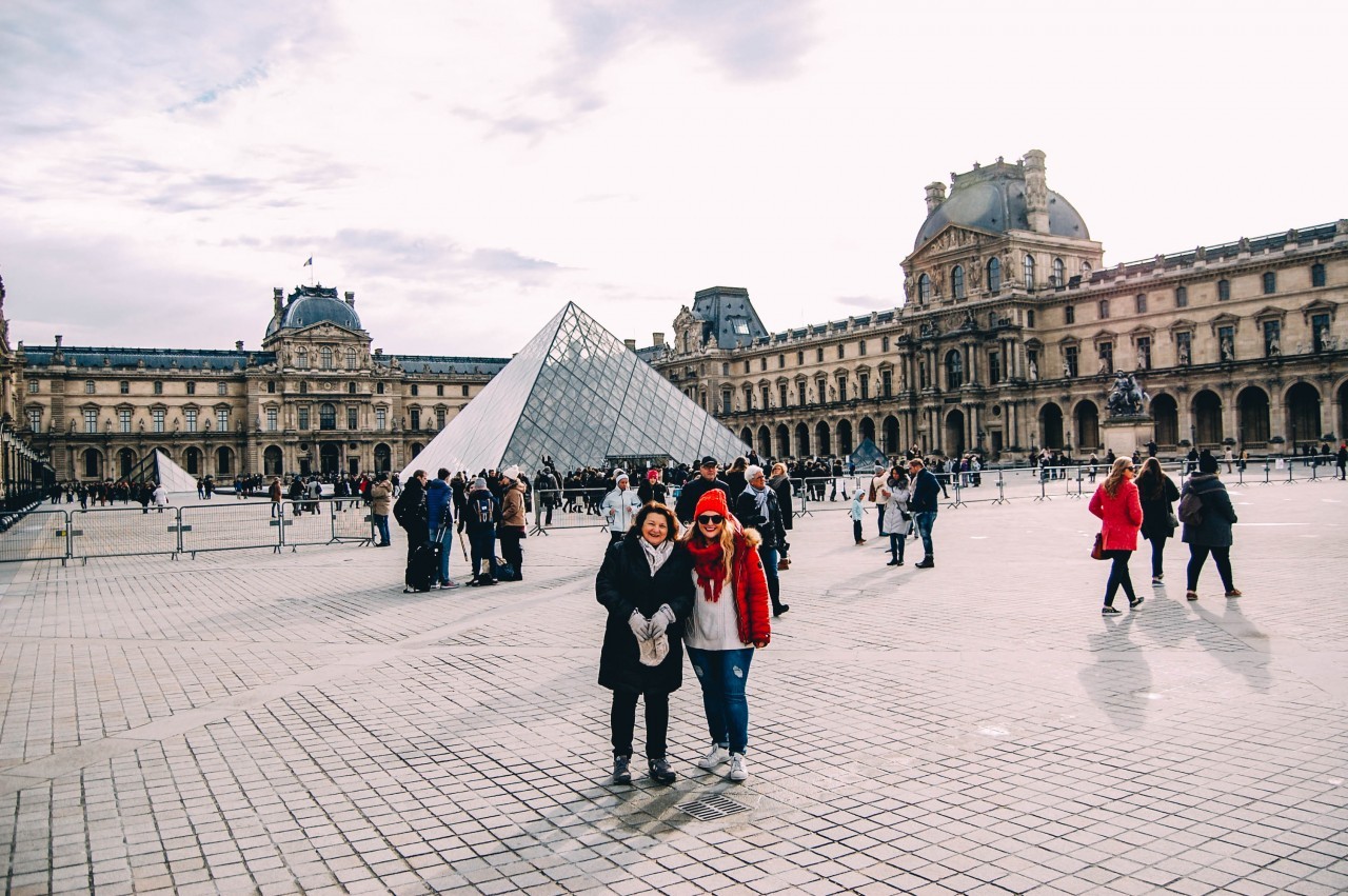 The iconic glass pyramid entrance of the Louvre Museum.