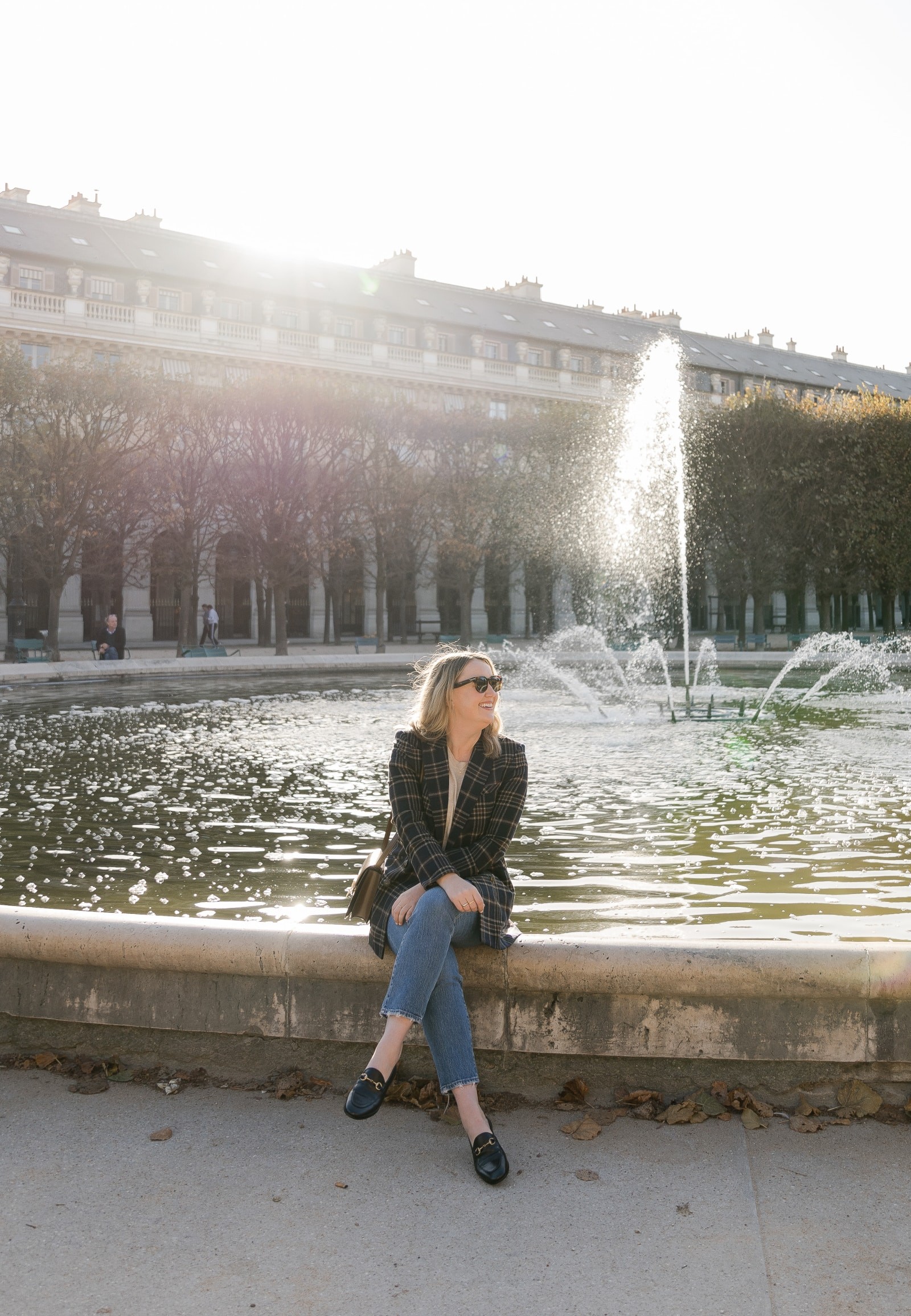 Woman in plaid blazer, demonstrating a stylish Europe outfit